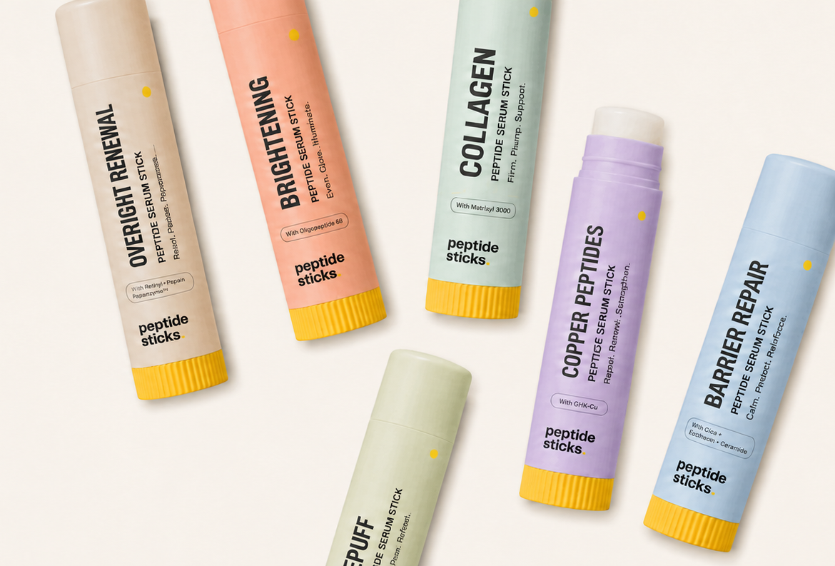 The six Peptide Sticks balm sticks laid out in a row: Overnight Renewal, Brightening, Collagen, Depuff, Copper Peptides, and Barrier Repair